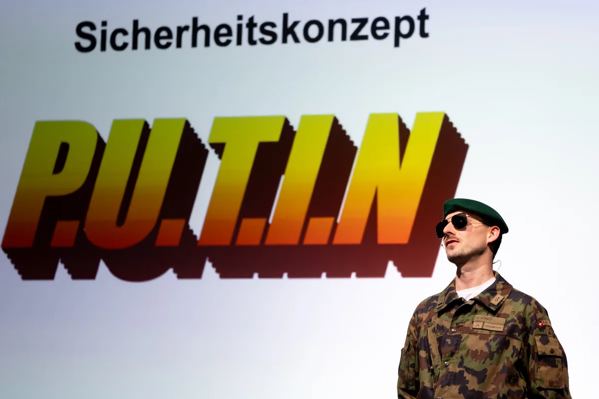 Cedric Schild steht als Militarist verkleidet vor einer Leinwand.